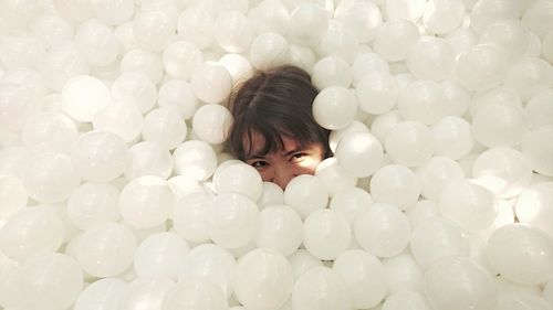 Close-up portrait of a girl with balloons