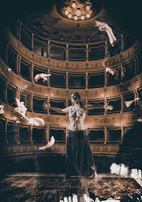 Woman looking at illuminated traditional building