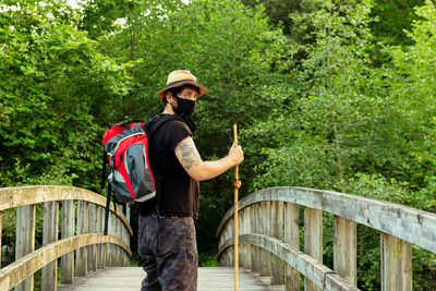 Full length of man standing on bridge