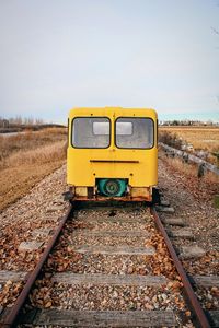 Train on railroad track against sky