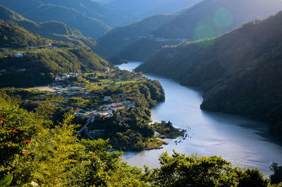 High angle view of river amidst mountains against sky