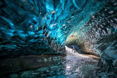 Man standing in frozen cave