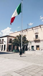 Flag against buildings in city