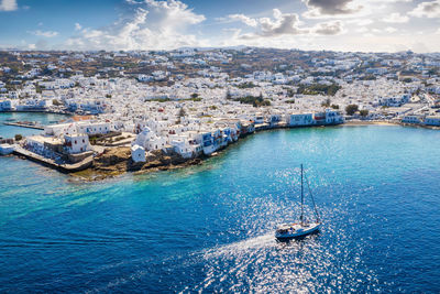 High angle view of cityscape by sea against sky