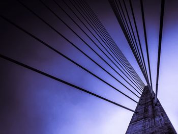 Low angle view of bridge against cloudy sky