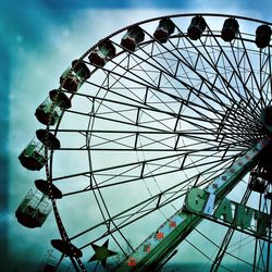 Low angle view of ferris wheel against sky