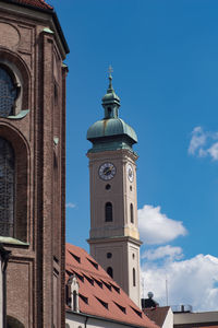 Low angle view of bell tower against blue sky