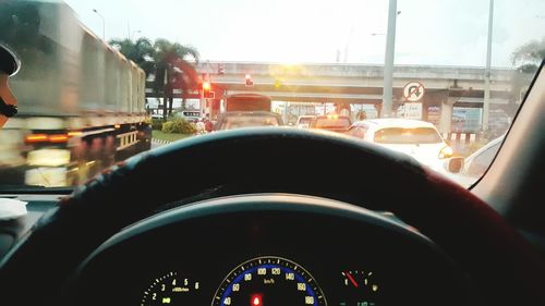 View of cars on street seen through car windshield