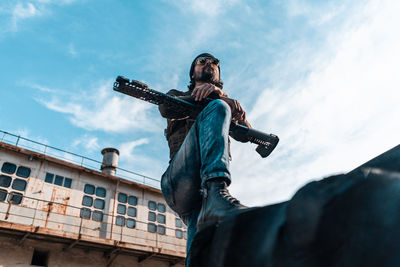 Low angle view of statue against building against sky