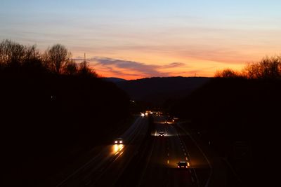 High angle view of illuminated road against sky at night