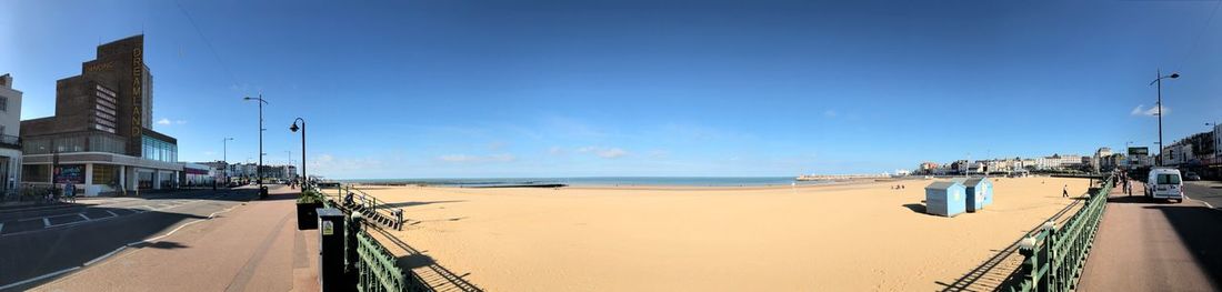 Panoramic view of buildings by sea against sky