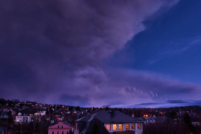 Illuminated buildings against sky at night