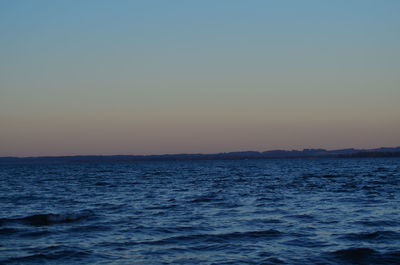 Scenic view of sea against clear sky during sunset