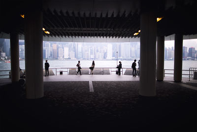 People overlooking river against buildings