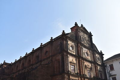 Low angle view of old building against blue sky