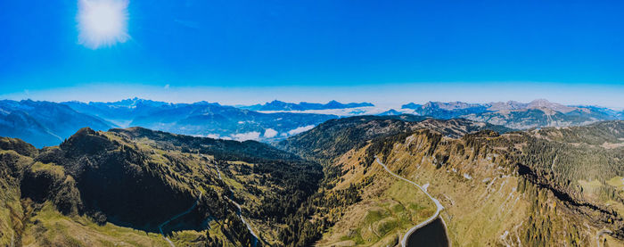 Panoramic view of mountain range against blue sky