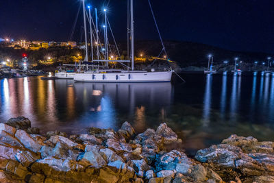 Sailboats in sea against sky at night