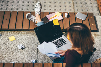 Low section of woman using laptop