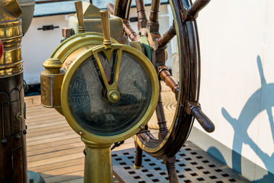 High angle view of ship throttle and steering wheel