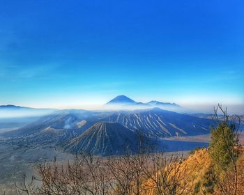 Scenic view of snowcapped mountains against blue sky