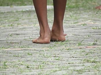 Low section of man standing on grass