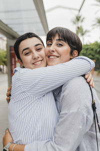 Smiling lesbian couple embracing each other