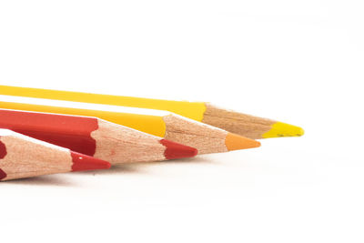 Close-up of colored pencils against white background