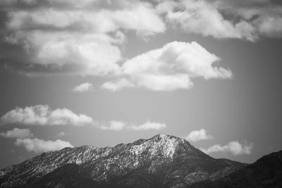 Scenic view of mountains against cloudy sky