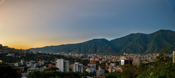Townscape against sky during sunset