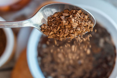 Close-up off instant coffee falling from a spoon