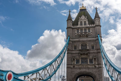 Low angle view of clock tower against cloudy sky