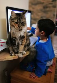 Cute boy sitting on table