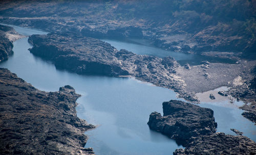 High angle view of rocks by sea