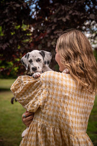 Rear view of woman with dog