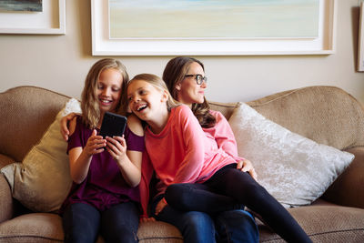 Portrait of smiling girl sitting on sofa