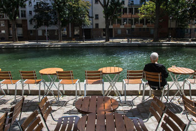 Lonely man sitting at a terrace along the canal saint martin in paris