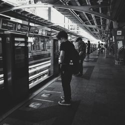 Full length of man standing at railroad station