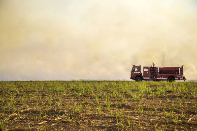 Barn on field against sky