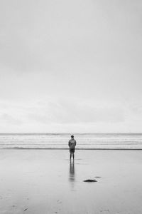 Rear view of man standing on beach