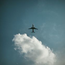 Low angle view of airplane flying in sky