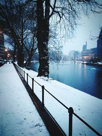 Scenic view of snow covered city against sky