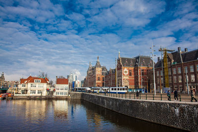 Canals, central railway station and tram at the old central district of amsterdam