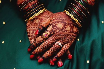 Midsection of bride with henna tattoo