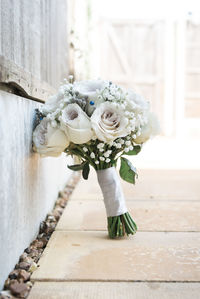 Close-up of white rose bouquet on wood