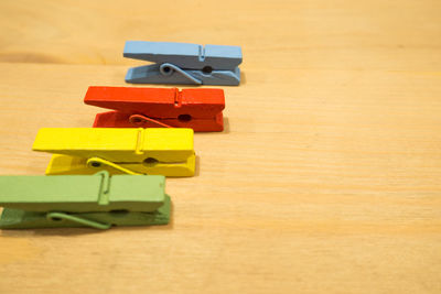 High angle view of colorful clothespins on table