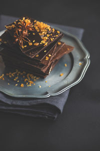 Close-up of chocolate bars with star anise in plate on table