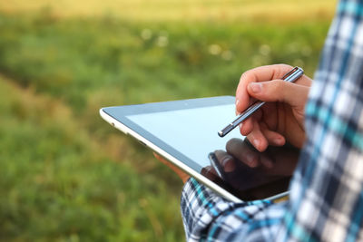 Midsection of woman using mobile phone