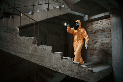 Rear view of man standing against wall