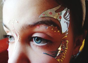 Close-up of woman with decorative beauty product