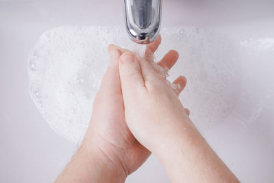 Midsection of person feet in water at home